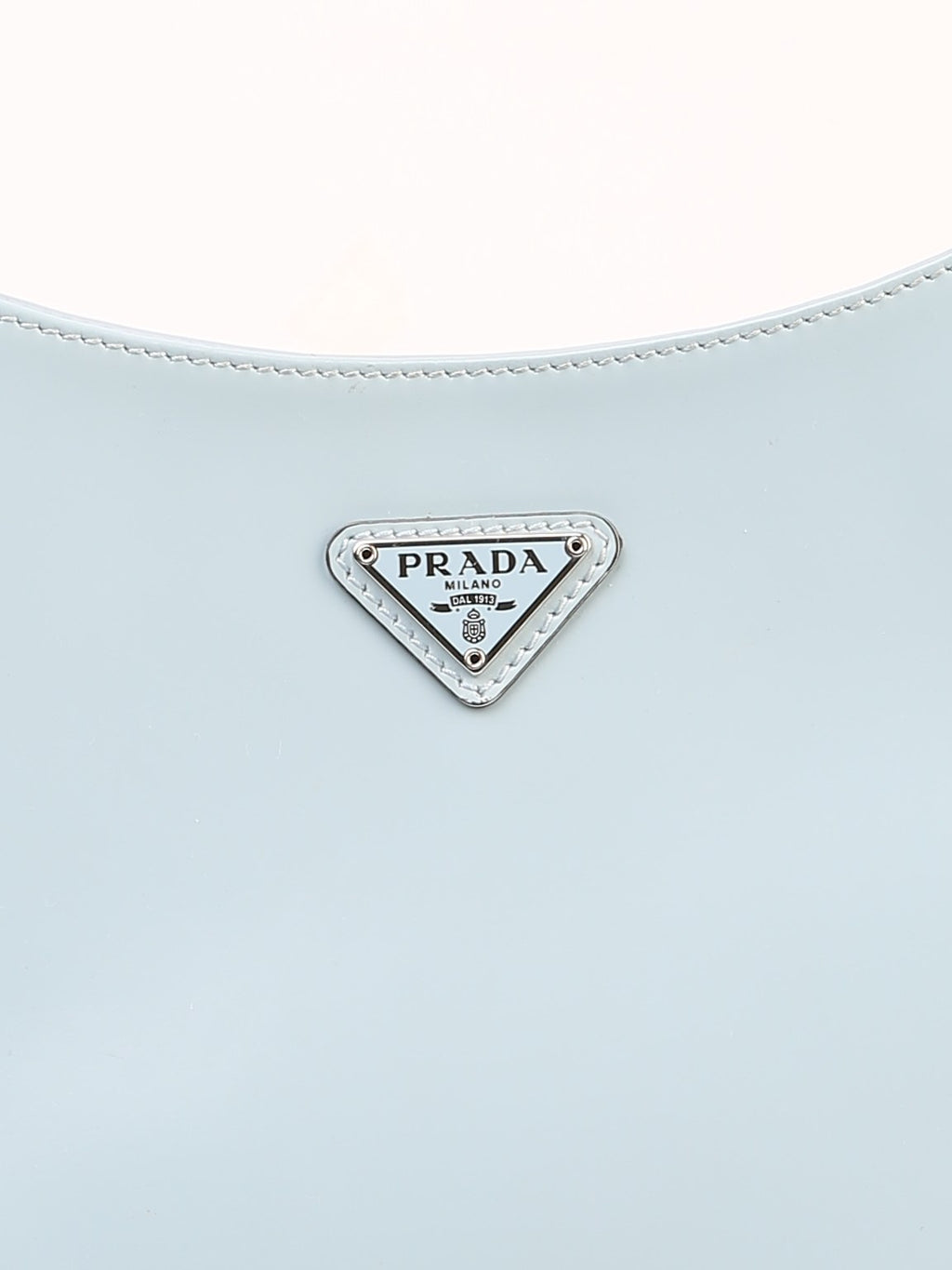 Bolsa Prada Cleo, couro liso azul gelo, detalhe da placa triangular metálica com a gravação Prada Milano — Domus Giulietta